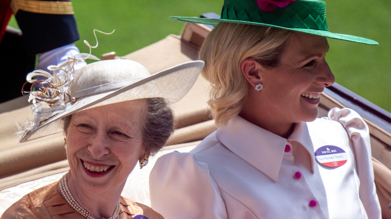 Princess Anne and Zara Tindall smiling in a carriage