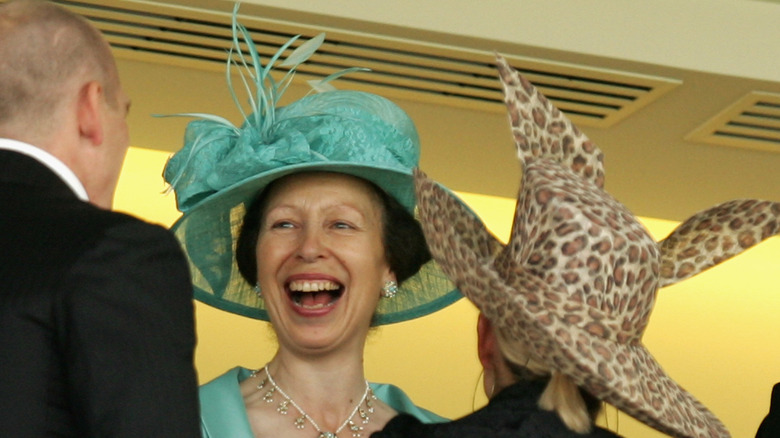 Princess Anne laughing with Mike Tindall and Zara Tindall