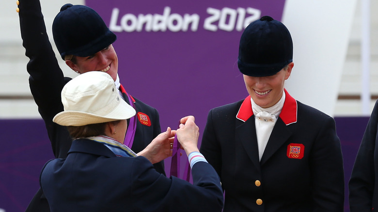 Princess Anne presents Zara Tindall with a silver medal