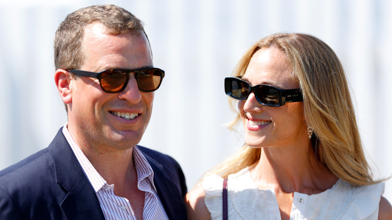 Harriet Sperling smiling at Peter Phillips while wearing sunglasses