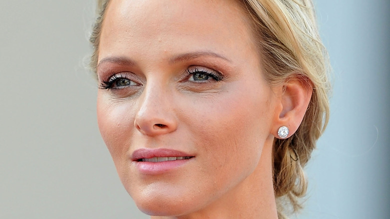 Princess Charlene softly smiling at an event