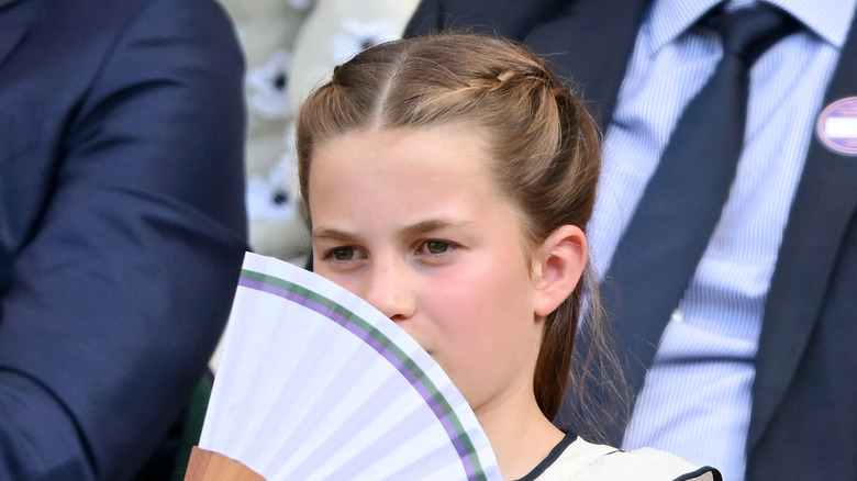 Princess Charlotte holds a fan