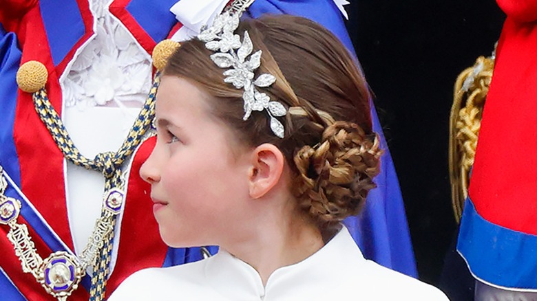 profile of Princess Charlotte looking serious with her hair up