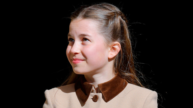 Princess Charlotte smiling in a brown coat