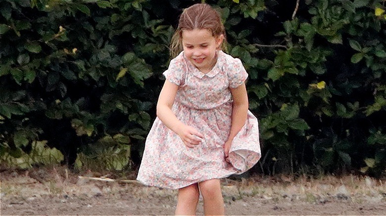 Princess Charlotte playing outdoors in a floral dress