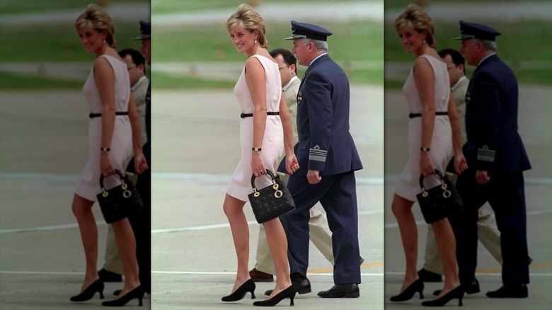 Princess Diana smiling and walking