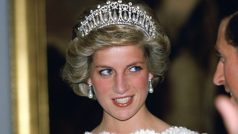 Princess Diana glancing mischievously to the side at King Charles