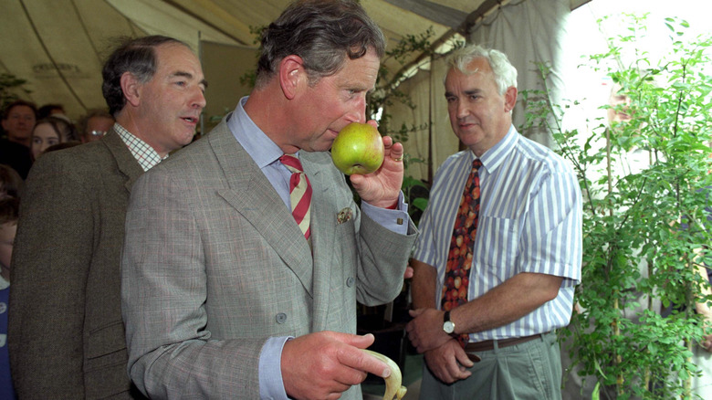 Prince Charles sniffing an apple about a year after Princess Diana's death.