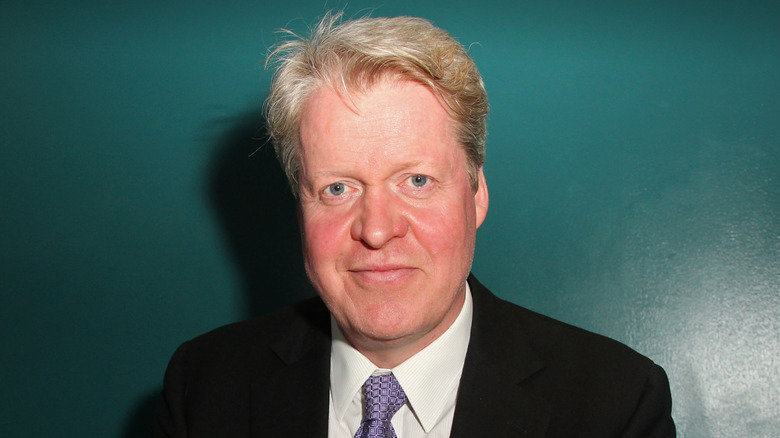 Charles Spencer against green background