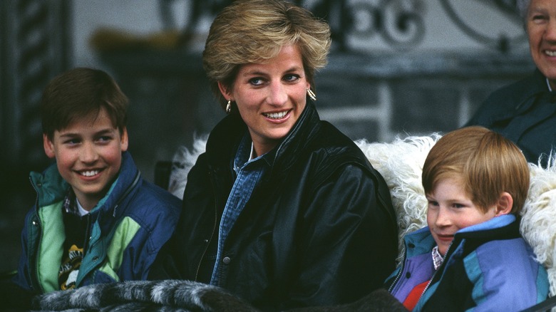 Princess Diana with William and Harry sitting in sled