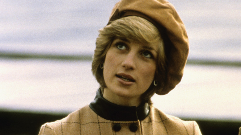 Young Princess Diana looking up at the sky while her picture is taken