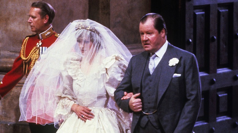 Diana walking with her father on her wedding day