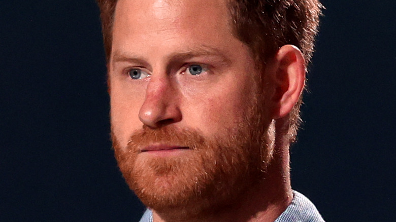 Prince Harry looks pensive onstage