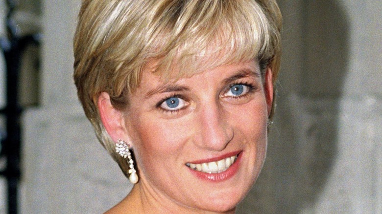 Princess Diana wears a white dress.