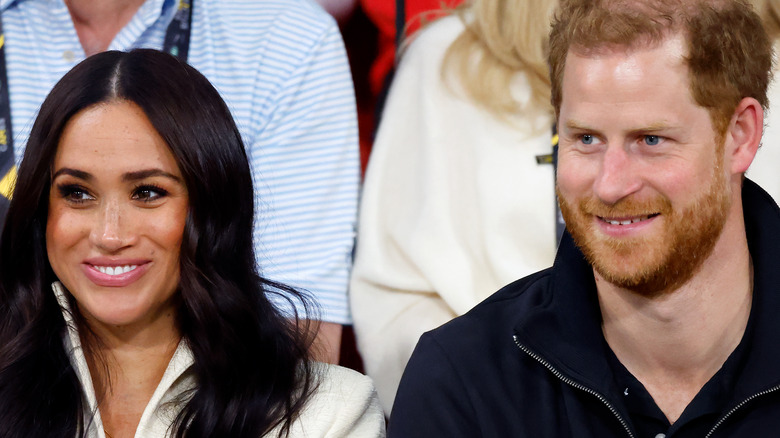 Meghan Markle and Prince Harry smile at the polo