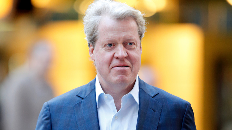Charles Spencer attending an event in a navy suit