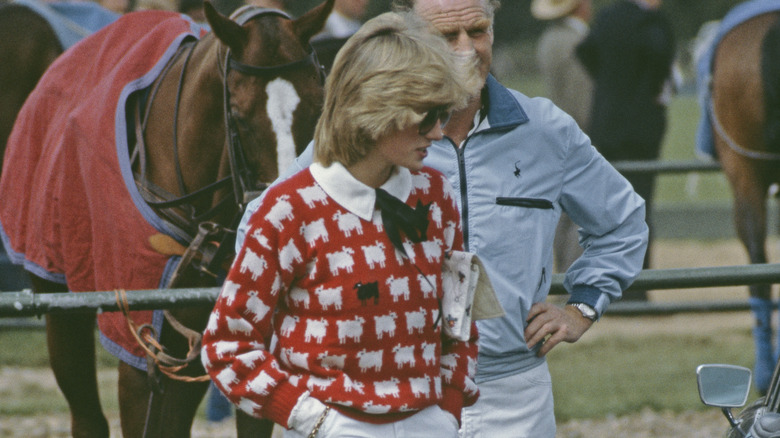 Princess diana in red sheep sweater in front of horse