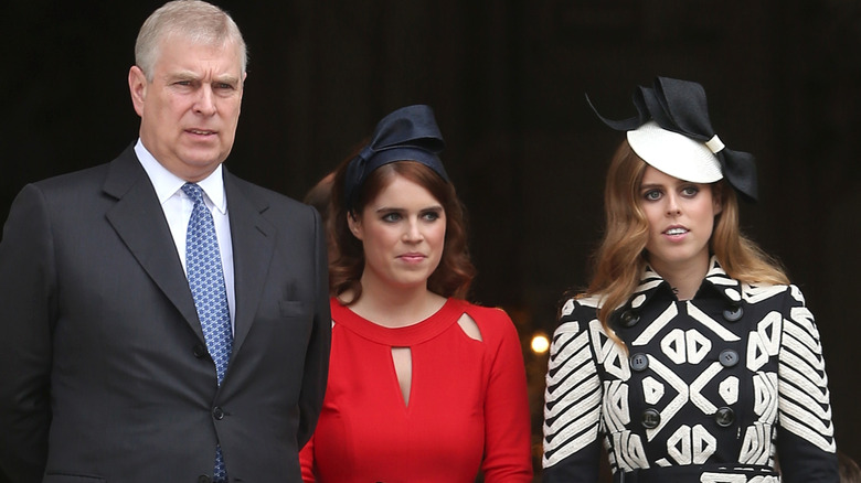 Prince Andrew standing with Princess Eugenie and Princess Beatrice