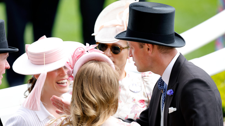 Prince William playing with Princess Eugenie's hat at Royal Ascot