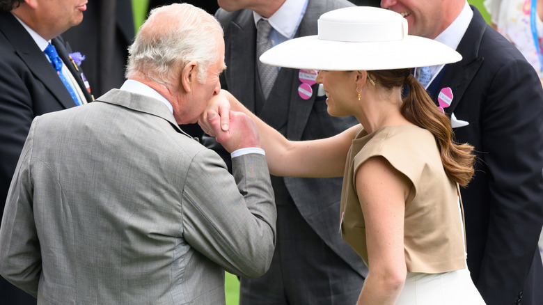 King Charles kisses Princess Eugenie on the hand