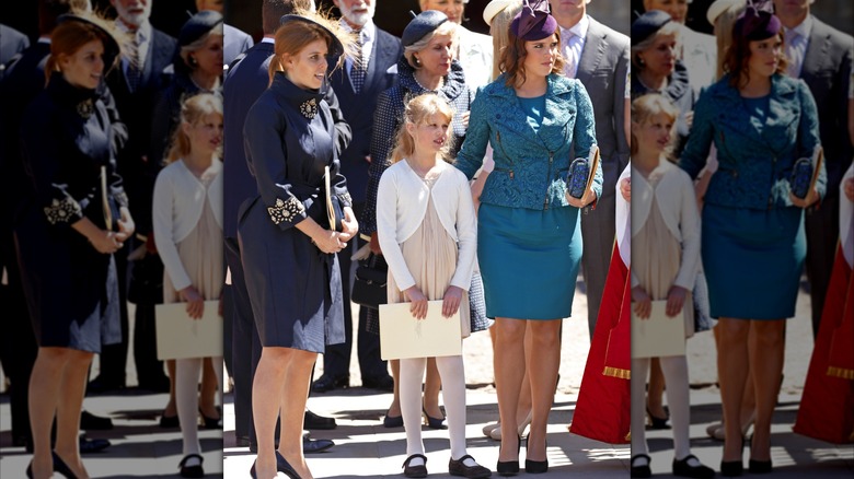 Princess Eugenie in forest green with Princess Beatrice in black and a young guest at the 60th Anniversary of the Queen's coronation