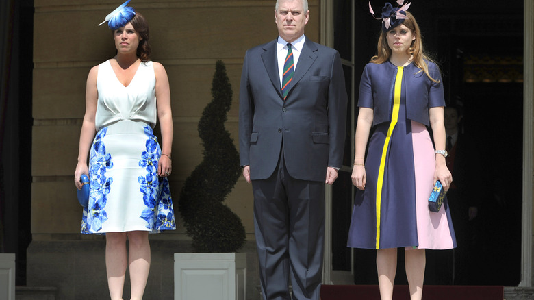 Princess Eugenie in white and blue, Prince Andrew in a suit and Princess Eugenie at Buckingham Palace in May 2016