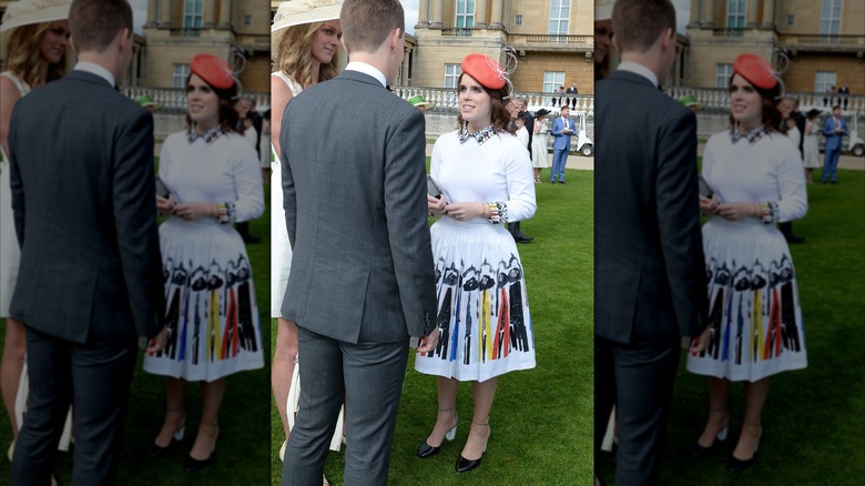 Princess Eugenie talking to a man at the Queen's Garden Party in 2016