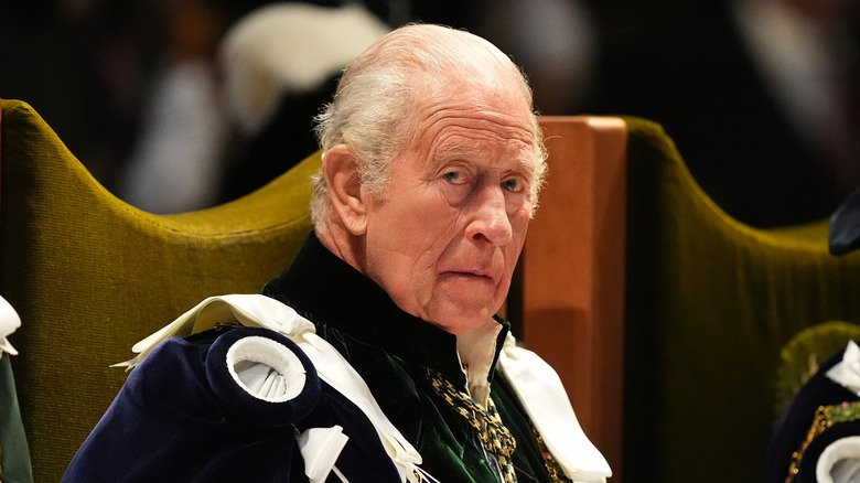 King Charles sitting during Holyrood service looking concerned