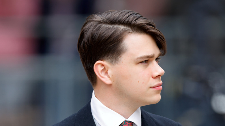 Samuel Chatto looking off to one side