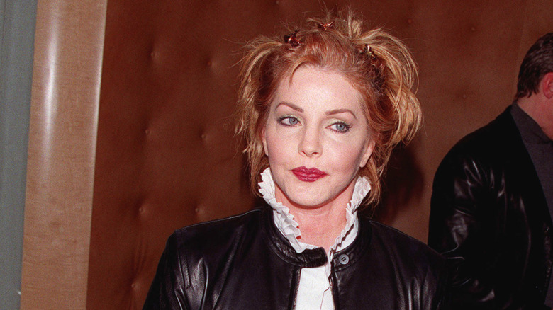 Priscilla Presley looking away at the camera