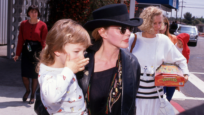 (l-r): Navarone Garibaldi Garcia and Priscilla Presley walking outside