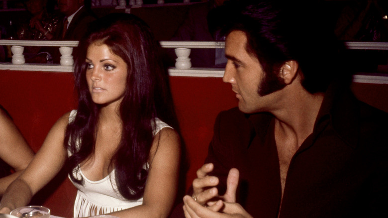 Elvis Presley looking at Priscilla Presley in bar