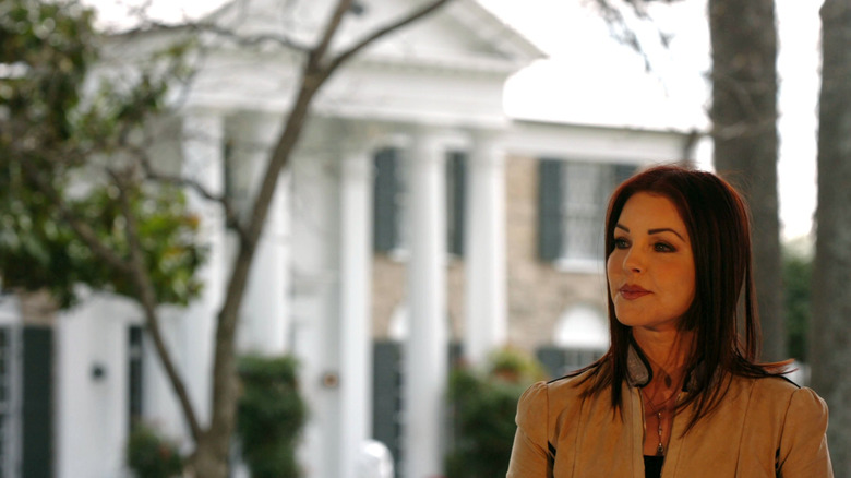 Priscilla Presley with Graceland in the background