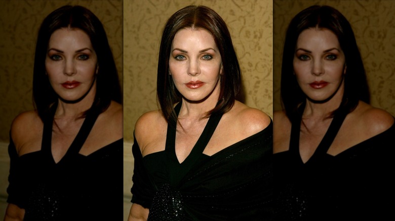 Priscilla Presley posing in a cutout black dress