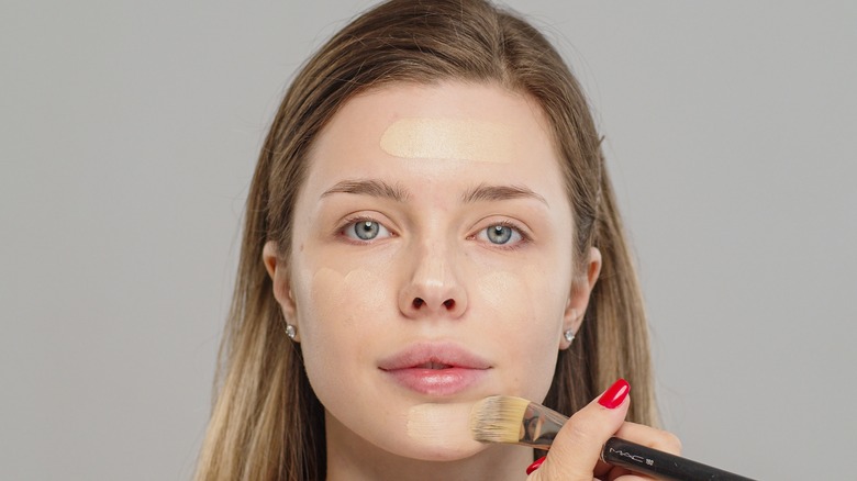 woman applying makeup