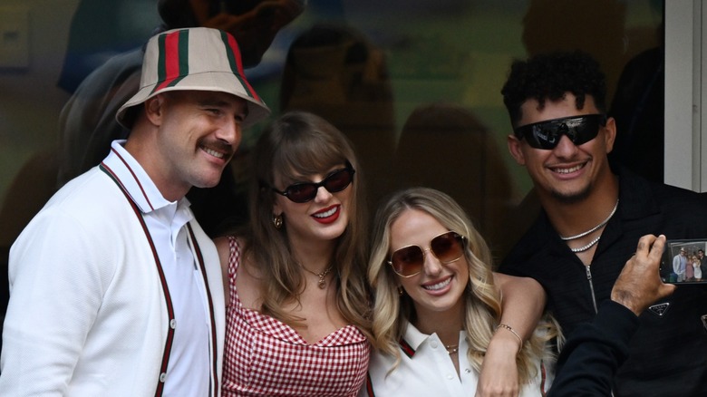 Travis Kelce, Taylor Swift, Brittany Mahomes, and Patrick Mahomes smile for a photo at the 2024 US Open tennis match