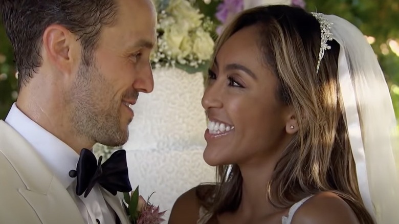 Zac Clark and Tayshia Williams wearing wedding attire