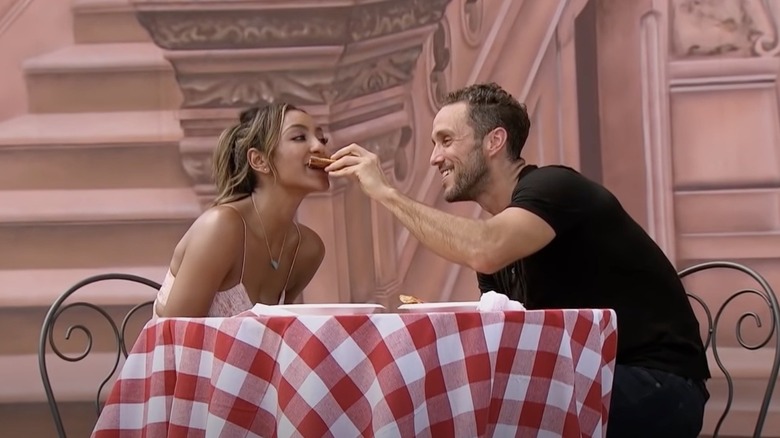 Zac Clark feeding Tayshia Adams pizza
