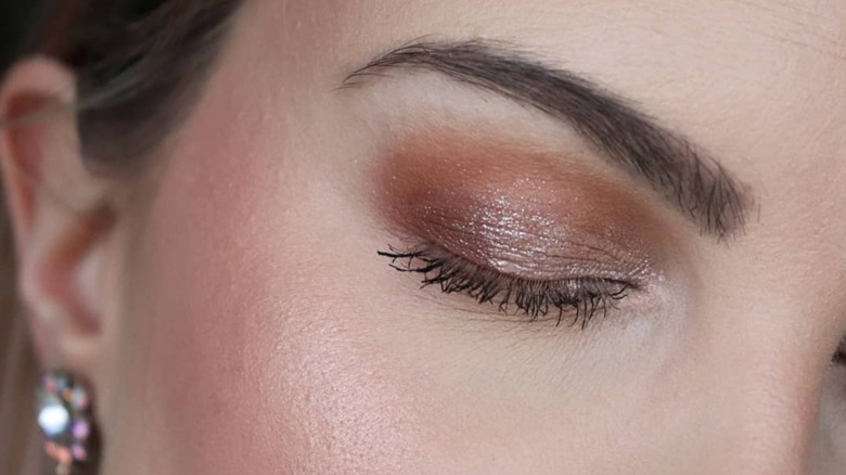 close-up of eyelid wearing eyeshadow stick