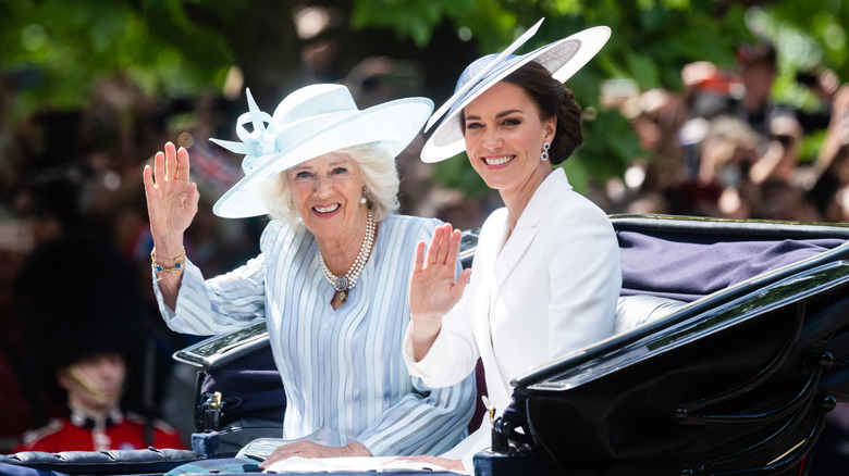 Queen Camilla (left) and Kate Middleton (right) waving