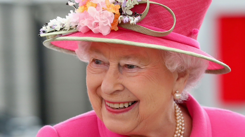 Queen Elizabeth wearing pink hat