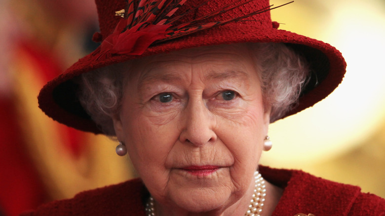 Queen Elizabeth looks wistful in an all-red outfit