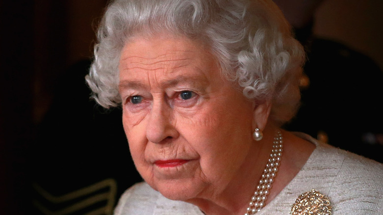 Queen Elizabeth wears white and pearls