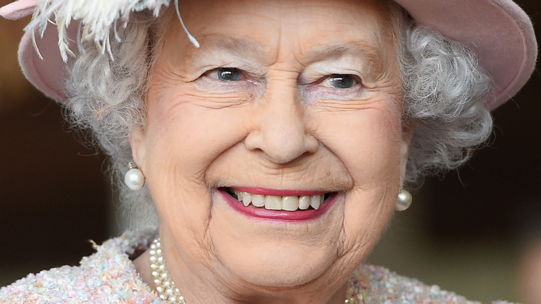 Queen Elizabeth smiling in pink