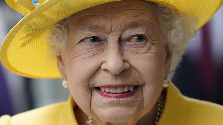 Queen smiling in yellow