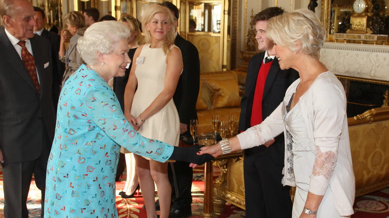 Queen Elizabeth II greeting Dame Helen Mirren at  Buckingham Palace in 2011
