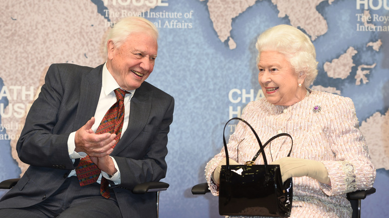 Sir David Attenborough and Queen Elizabeth II seated together at a ceremony in 2019