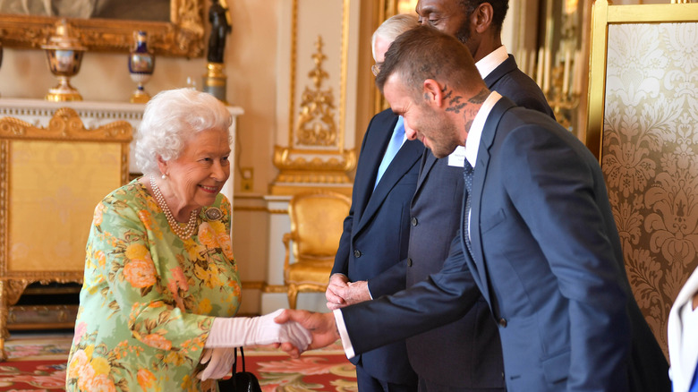 Queen Elizabeth II shaking David Beckham's hand in 2018