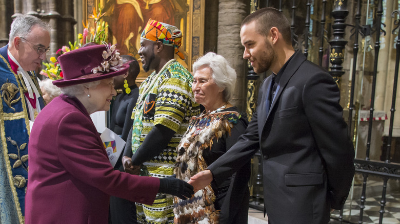 Queen Elizabeth II shaking Liam Payne's hand at Westminster Abbey in 2018