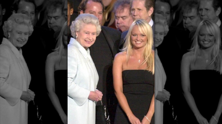 The Queen passes Spice Girl Emma Bunton on stage during "Party at the Palace" in London 03 June 2002